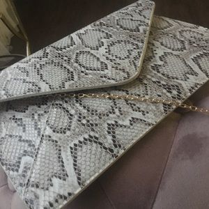 Snake print clutch with body chain